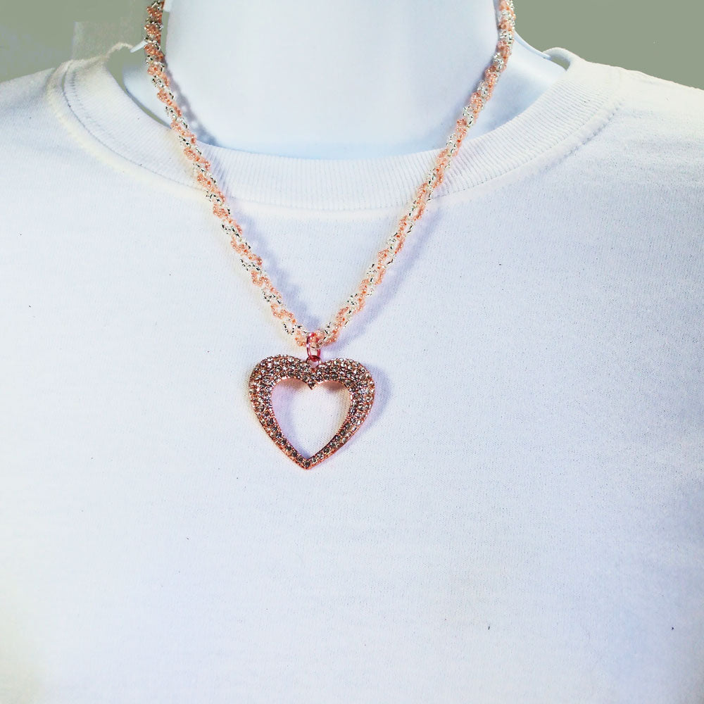 *Copper heart embedded with fave crystals.  Hangs from a seed beaded netting stitch neckwear in pink and silver seed beads. 