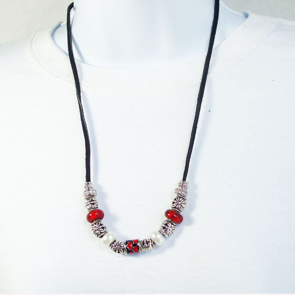 7548 *Red designer beads with white and silver accent beads. *Black leather cord neckwear.  Silver toggle clasp.