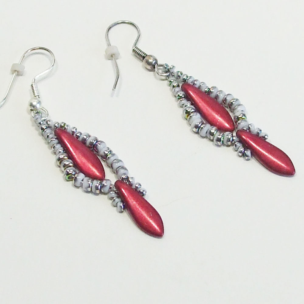 8033  *Hand crafted Earrings:  Red dagger bead dangle created with seed bead accent. *Copy of design on matching necklace.   Silver plated ear wires.