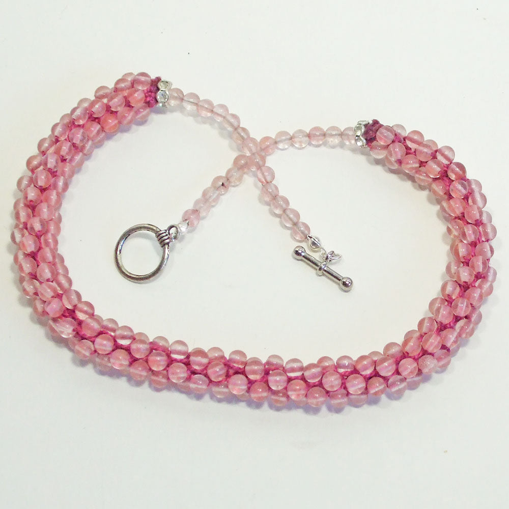 8119  *Pale pink beaded Kumihimo braided single strand necklace. *Size:  18 inch length around the neck.   *Silver toggle clasp.