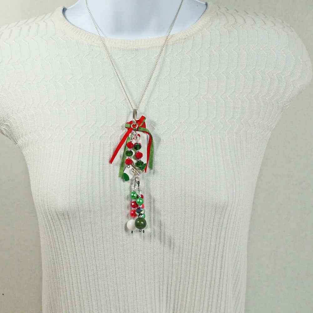 Christmas white wooden stocking pendant with water falls of beaded dangles.   2 hang from the top and 3 from the bottom.