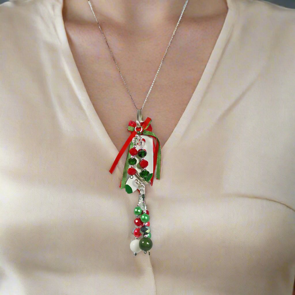 Christmas white wooden stocking pendant with water falls of beaded dangles.   2 hang from the top and 3 from the bottom.