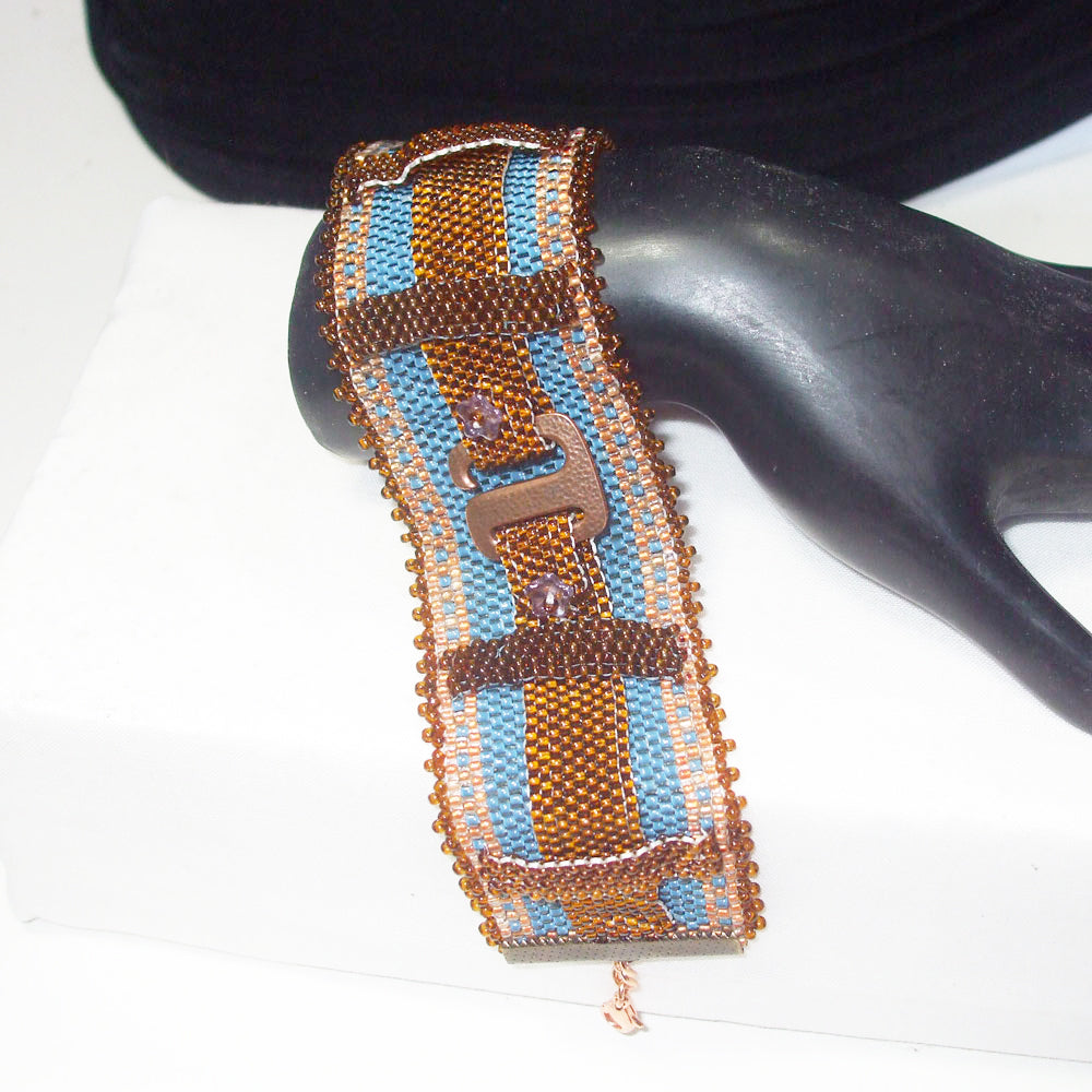 Hand Crafted, Peyote Stitch, Brown seed bead bracelet in Belt Buckle style.
Belt loops, and jean style colors create an allusion of wearing a belt buckle on your wrist.  
