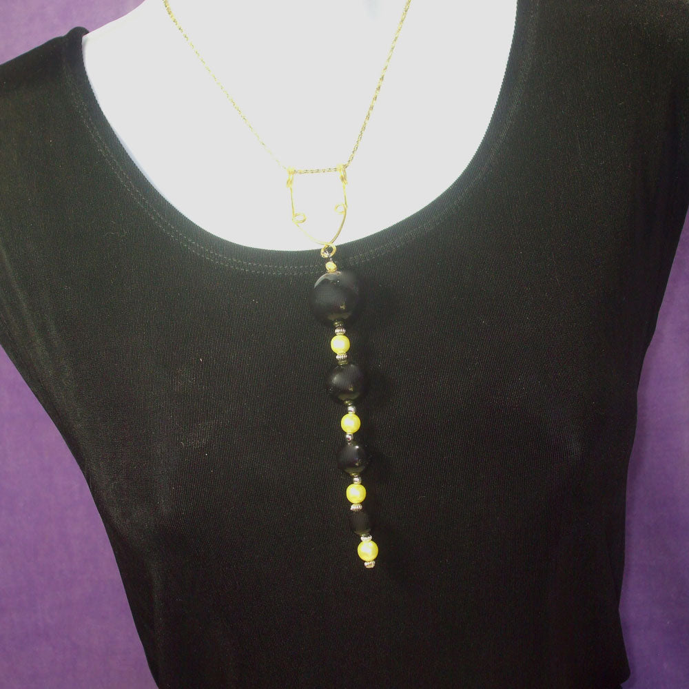 Black wood beads and yellow colored pearl beads dangle from droplet ‘Y’ Lariat bronze wire design pendant Necklace