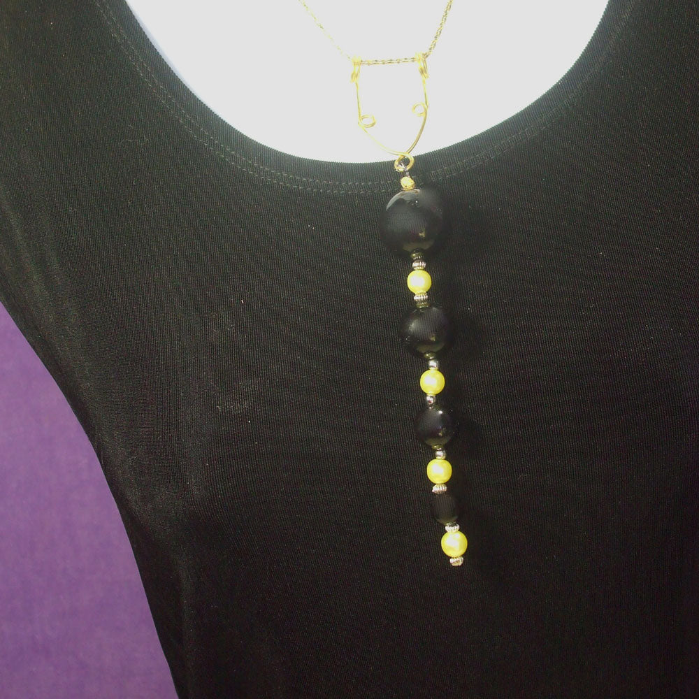 Black wood beads and yellow colored pearl beads dangle from droplet ‘Y’ Lariat bronze wire design pendant Necklace