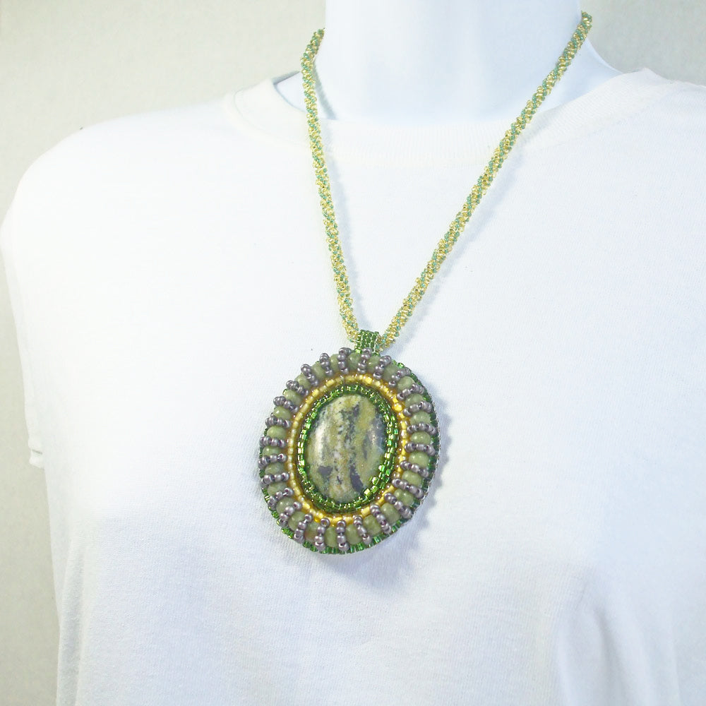 7520*Beautiful Zoisite mineral gem quality cabochon.   *Green, Gold, Gray bezel beads around cabochon.