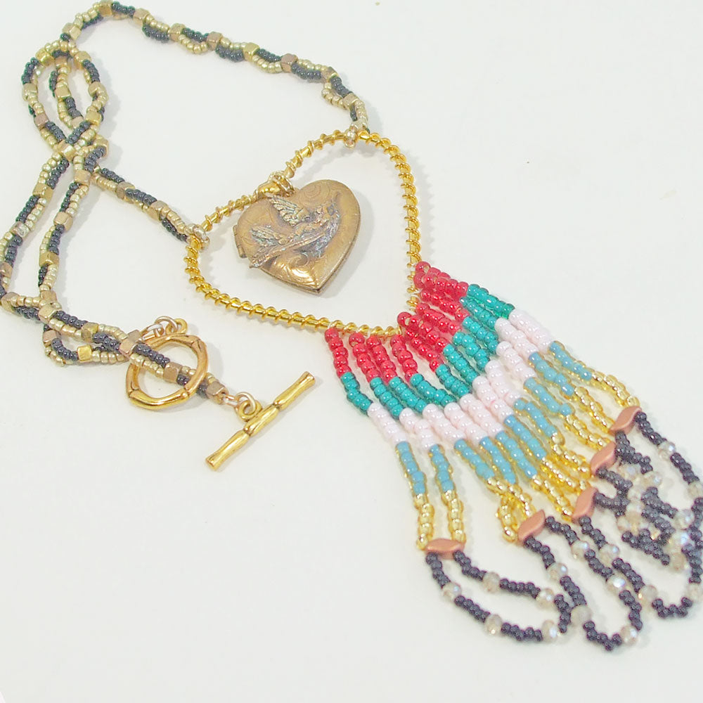 7522 *Gold Heart shaped hoop with gold heart locket and fringe. *Red, turquoise, pink, gold and black continuous fringe hanging from bottom.