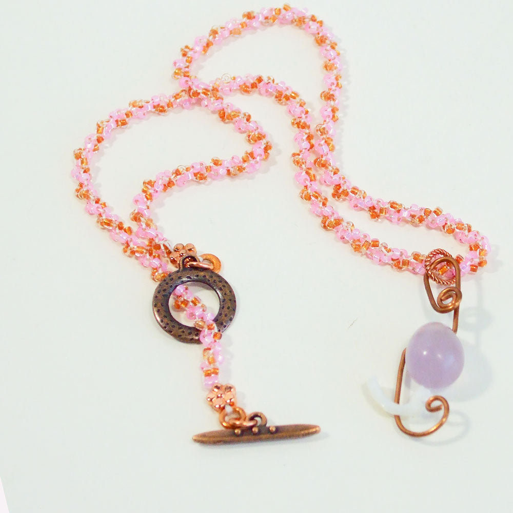7530 *Copper wire design with single light colored, purple Agate stone.  *Single Mother of Pearl bead accent drop.