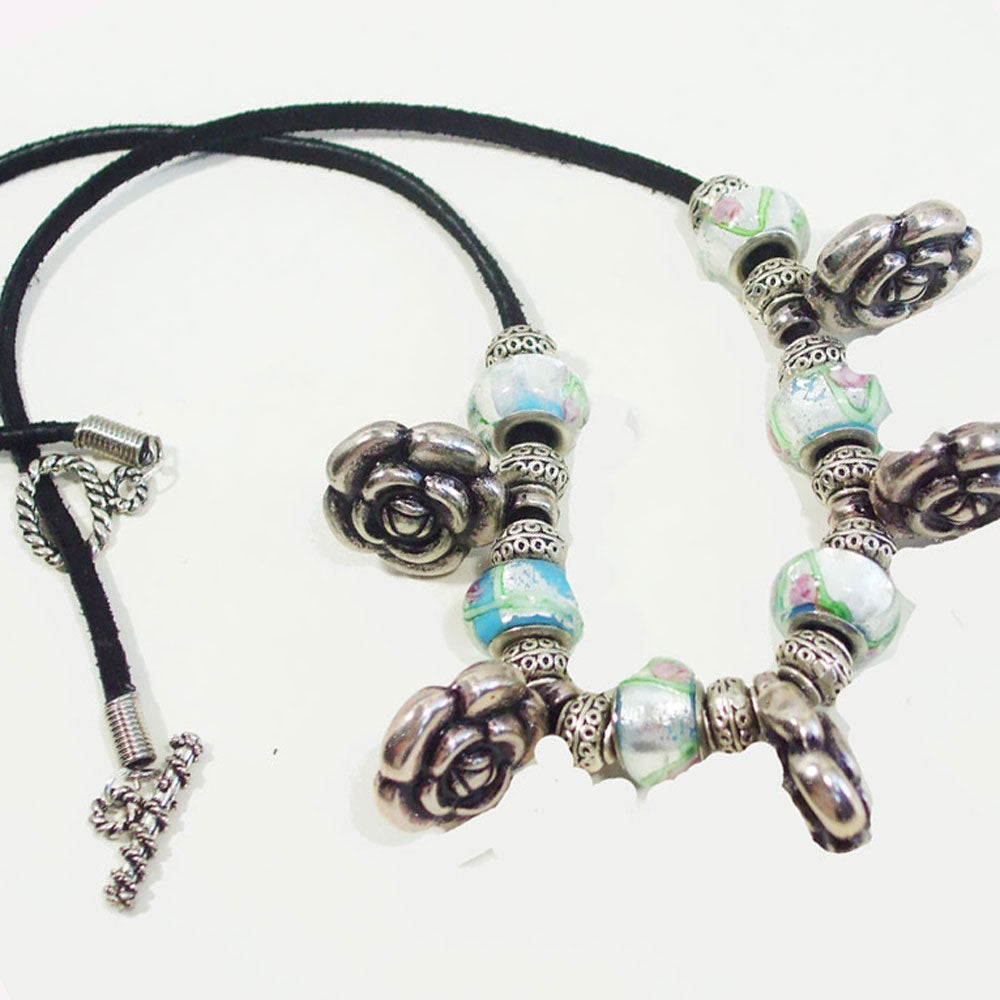 7538 *Large Silver Rose Beads with painted glass and small silver accent beads. *Black leather cord.  *Silver toggle clasp.
