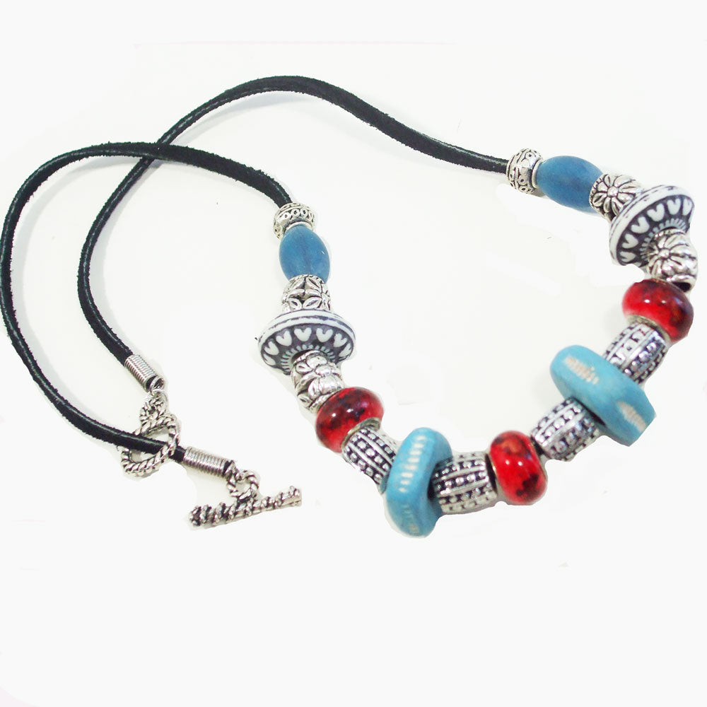 7540 *Custom made large beads in ceramics with red and blue glass beads. *Black leather cord and silver accent beads.  Silver toggle clasp.