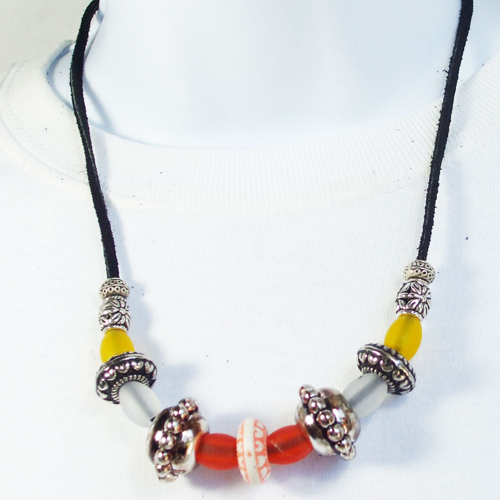 7542 *Black leather single cord with silver, white, red, and yellow beads. *Large silver designer beads and smaller colored accent beads.