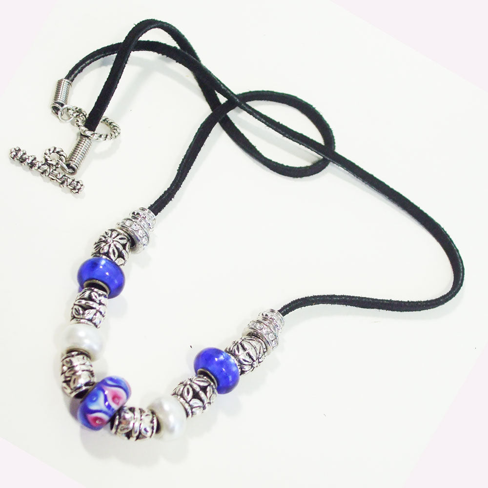 7546 *Blue designer beads with silver accent beads on black leather cord. *Size:  24 Inch around the neck.  Silver toggle clasp.