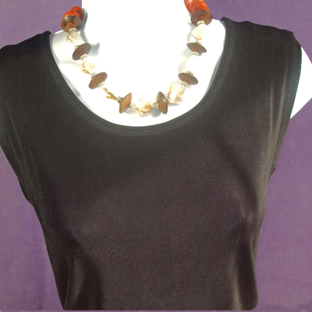 *Handmade, 7 Mother of pearl chip beads separated with dark brown wooden bicone beads and silver spacer beads. *Silver toggle clasp. *size:  17 inch around the neck.