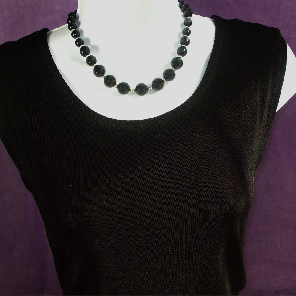 *Handmade, 27 black Ebony wooden graduated size beads separated by silver spacer beads. *Silver toggle clasp.   *size:  17 inch around the neck.