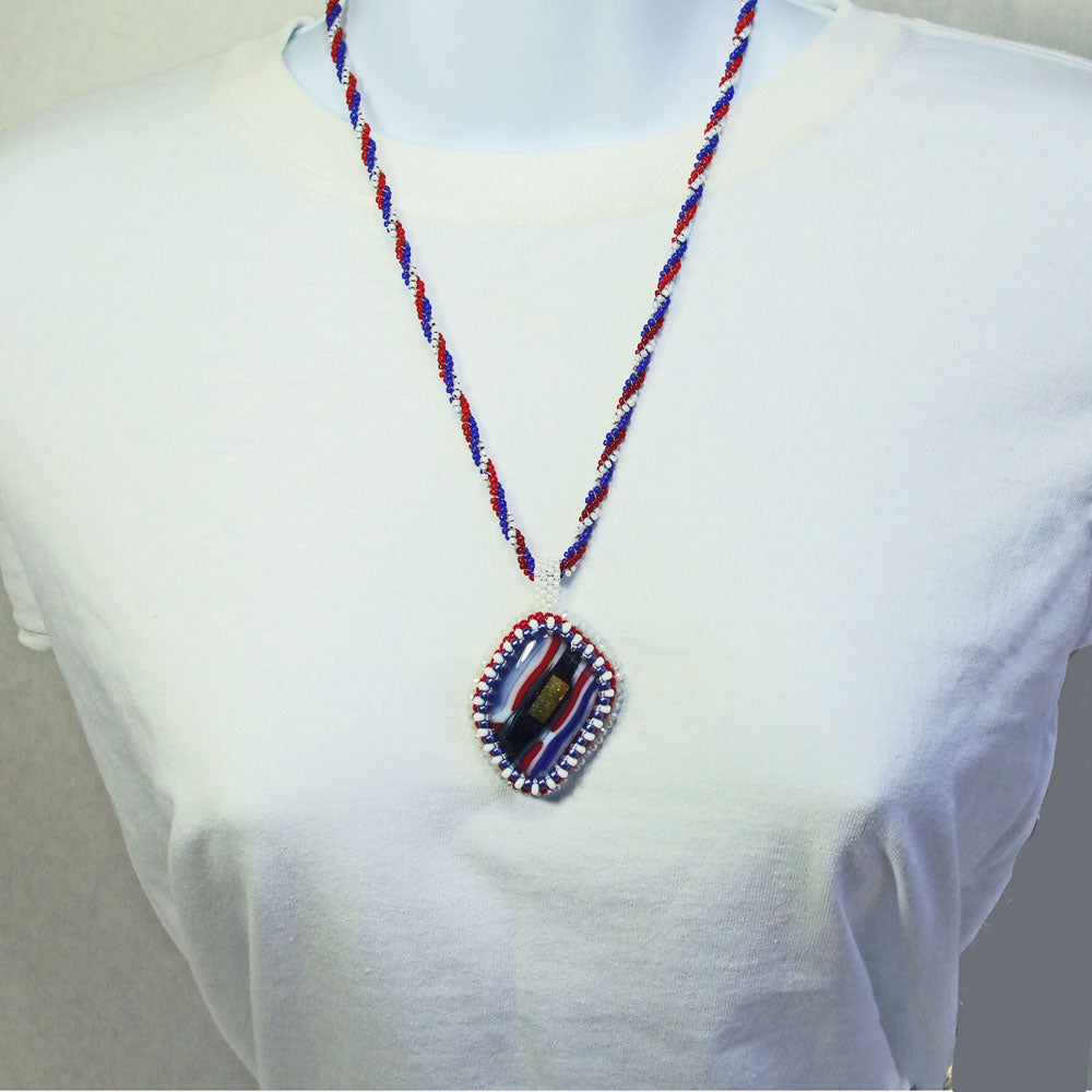 8125  *Multi colored melted glass cabochon, peyote stitch seed bead bezel, embroidery pendant, beaded necklace. *Red, White, Blue seed bead bezel around cabochon. 